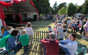 fire juggler entertaining crowd on front lawn. Farmleigh Estate