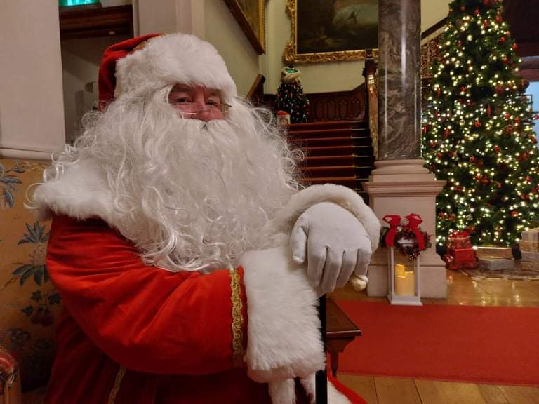 Santa Clause in front of Christmas tree in Farmleigh