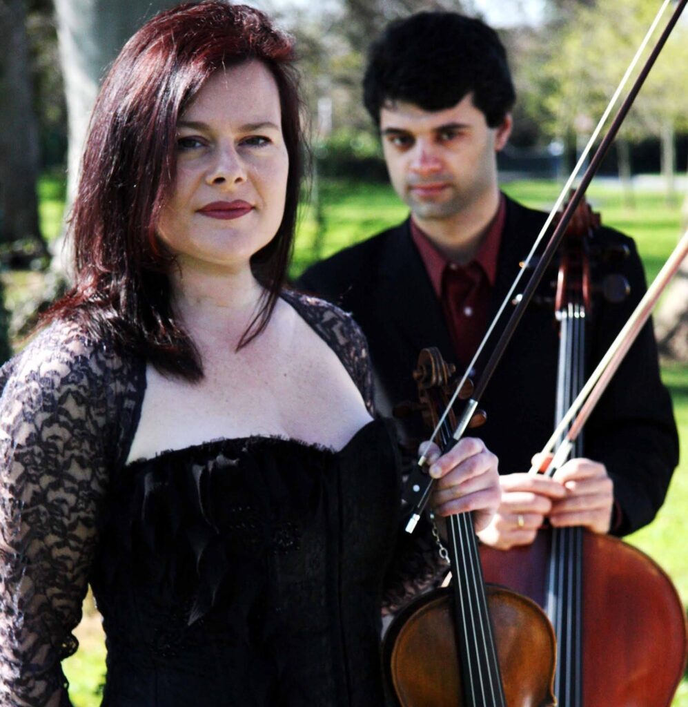Glamorous violinist and Cellist in outdoor setting